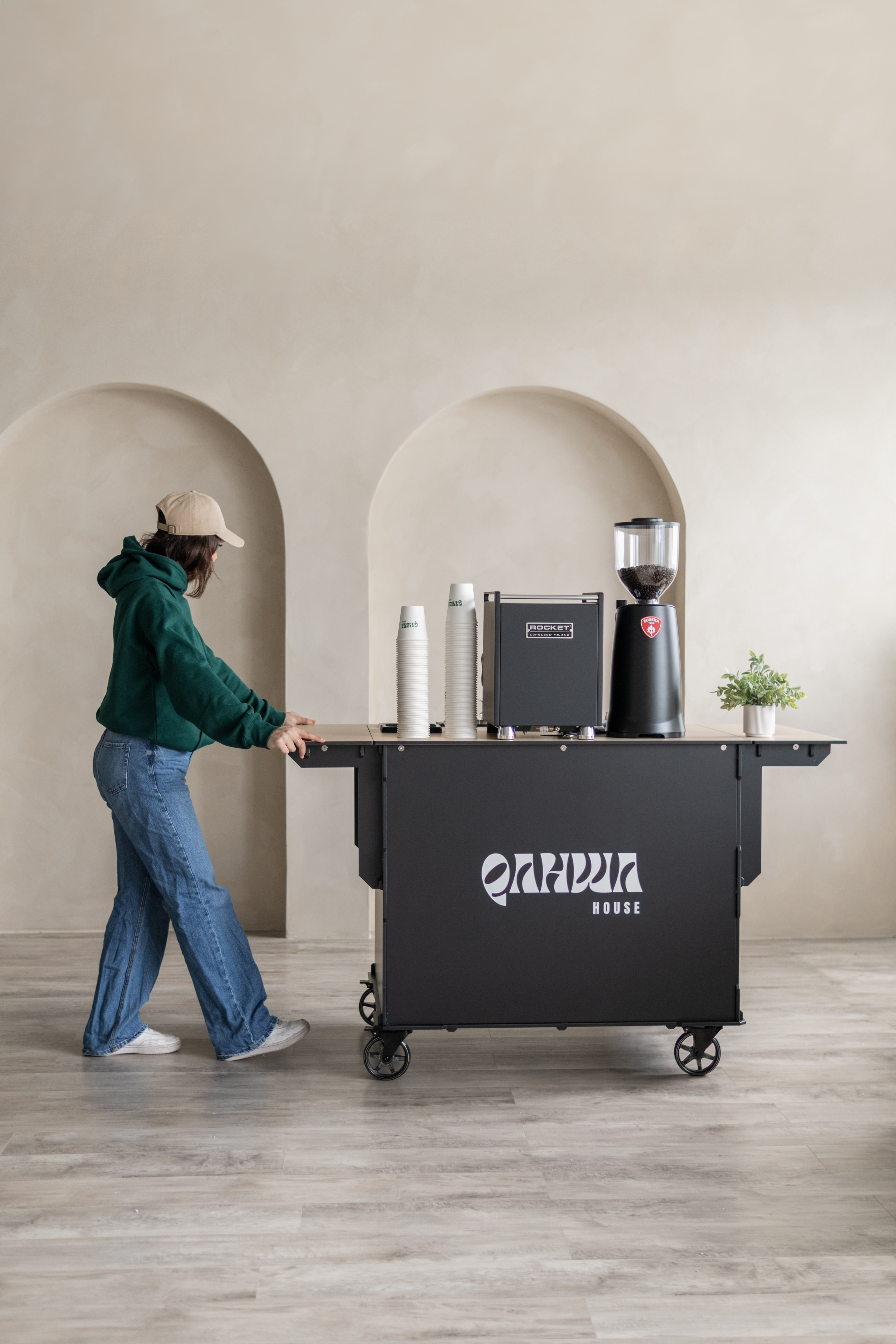 Two branded Qahwa Bar cups filling with espresso